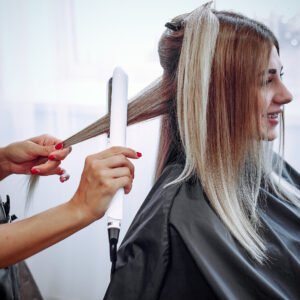 Hairdresser working with hear her client. Woman in a hair salon